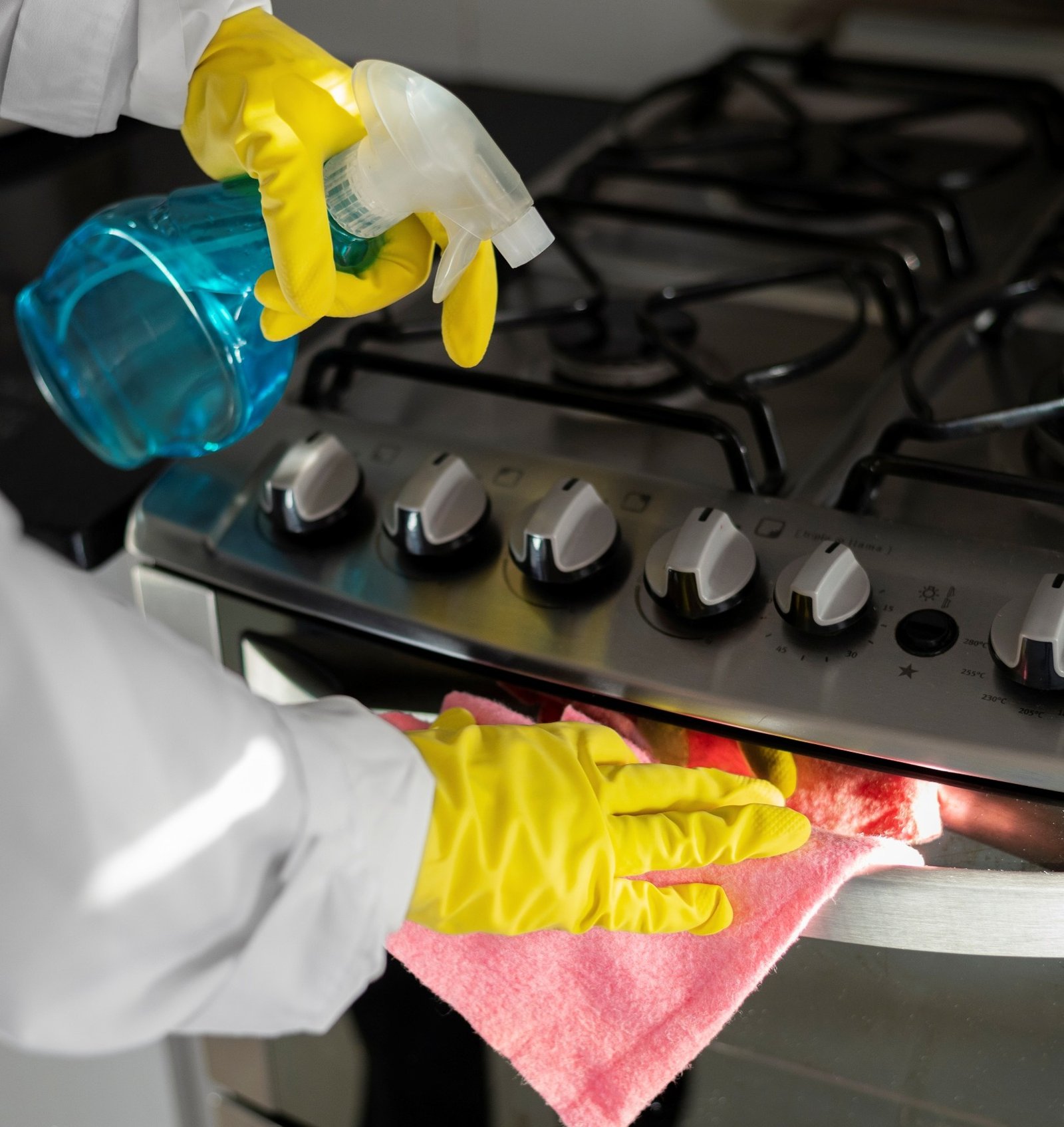 Cleaning kitchen in short-term rental property.